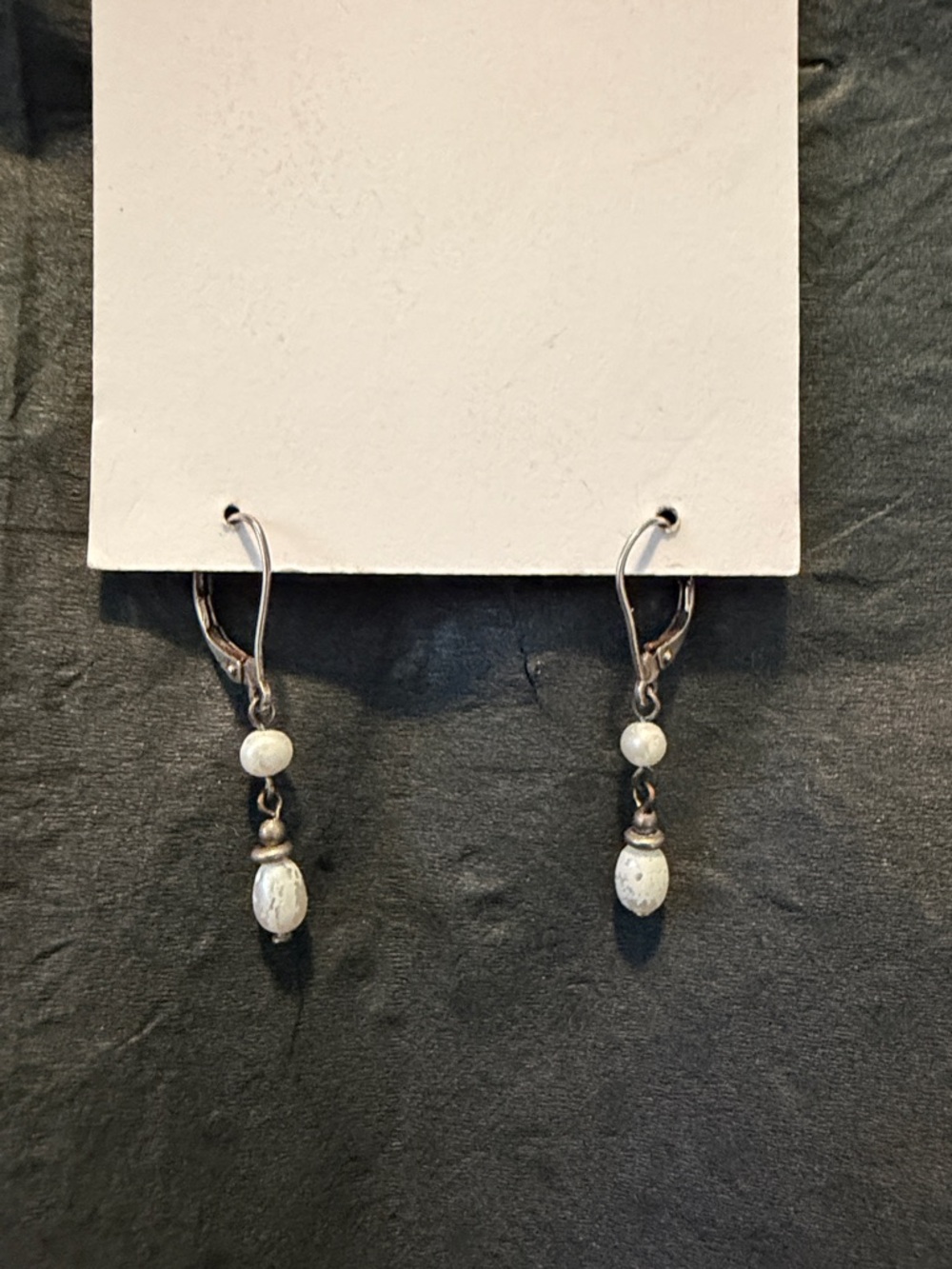Faux pearl with silver bead drop earring on silver wire with lever back.